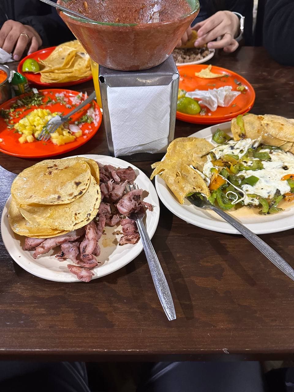 Table spread with tacos and salsa